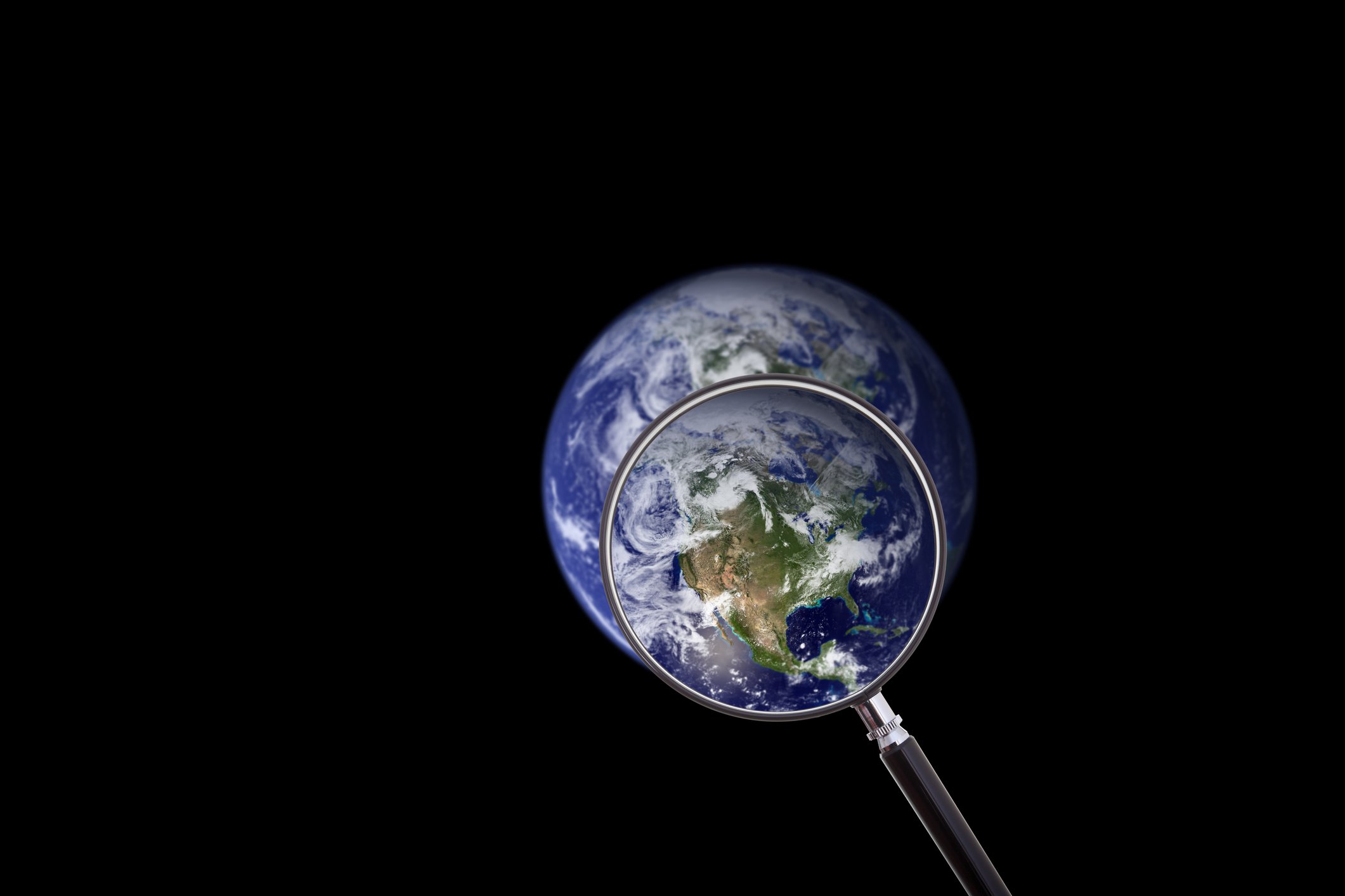 A magnifying glass over Earth, highlighting North America.