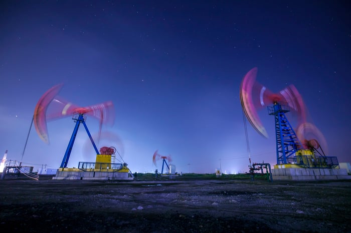 Oil pumps in motion at night.