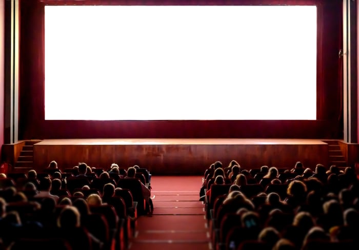A movie theater with a blank screen.