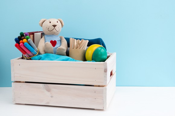 Toys in a wooden crate.