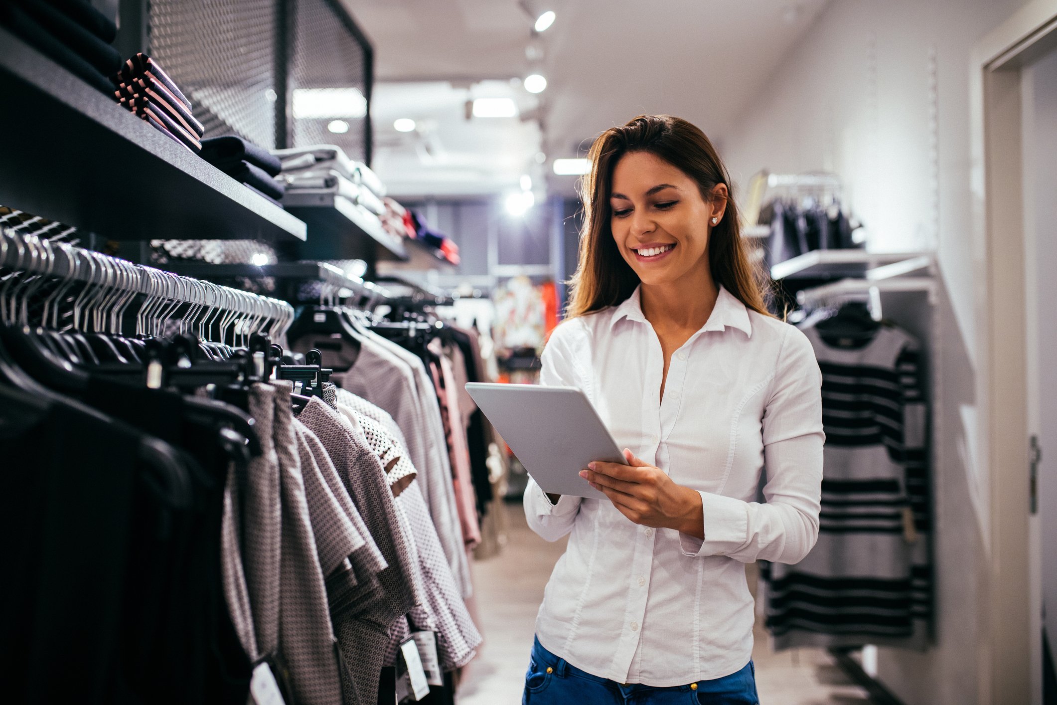 Woman shopping with a clipboard in a clothing store
