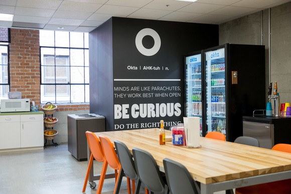 The breakroom at Okta headquarters, with the Okta logo on the wall.