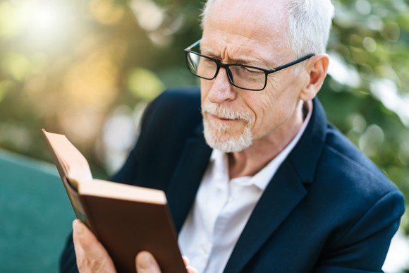Older man reading a book