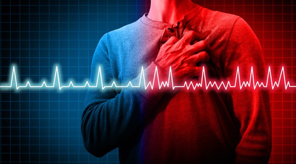 Man holding chest with heart rate graph superimposed.