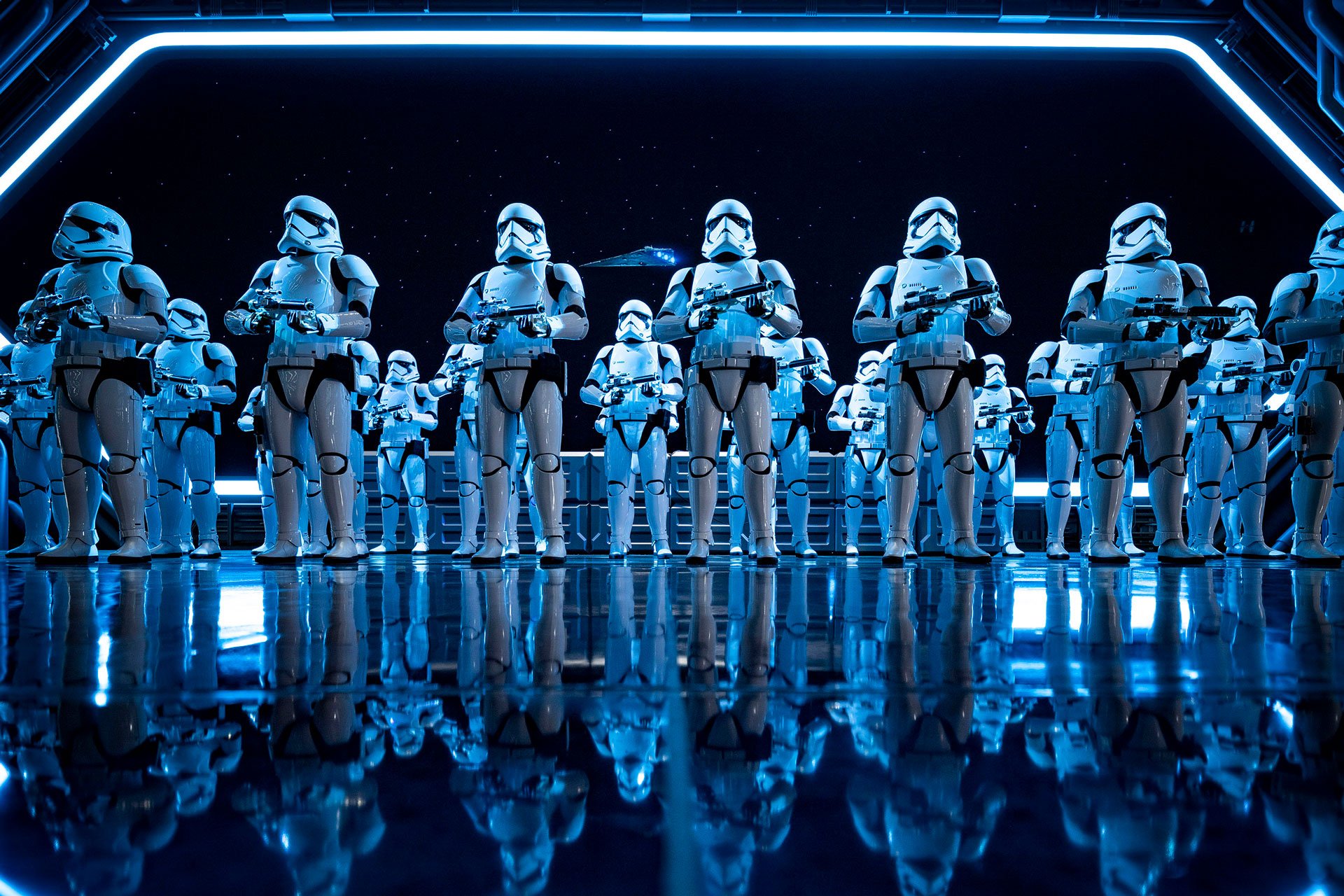 Storm troopers from star wars lined up on the deck of a space ship. 