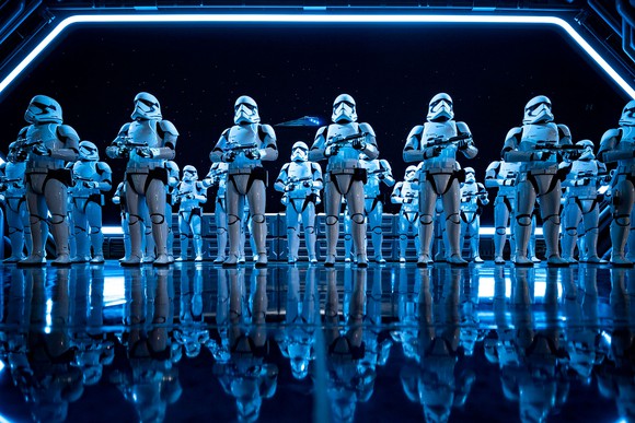 Storm troopers from star wars lined up on the deck of a space ship. 