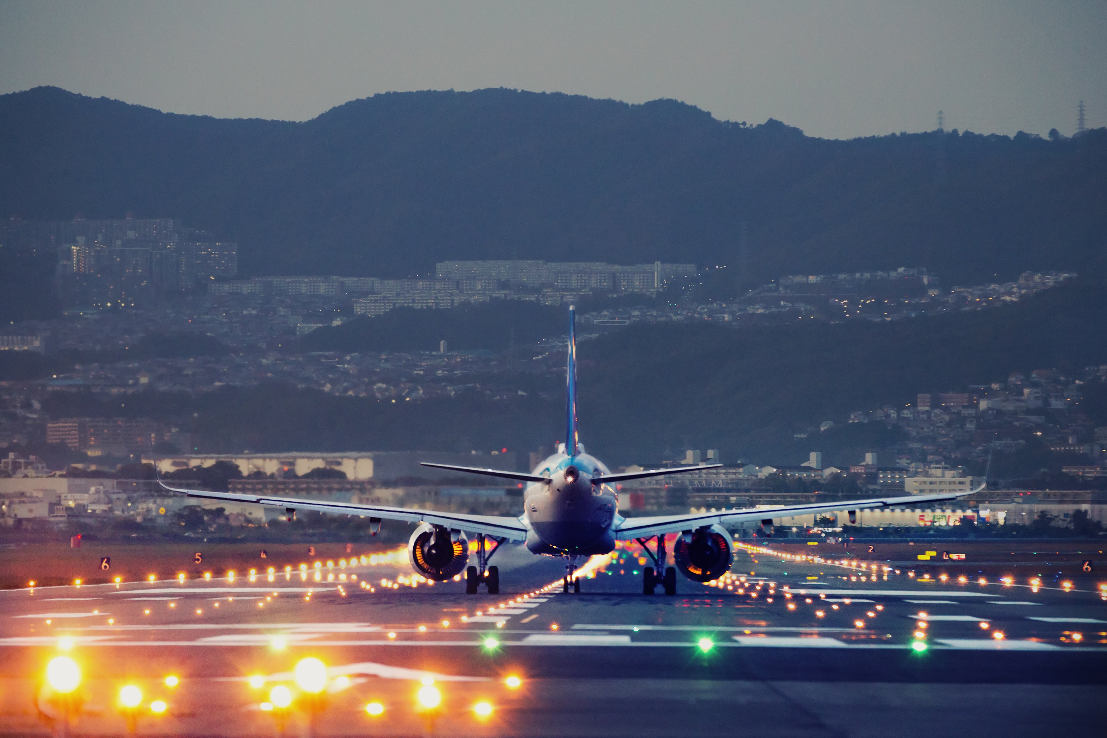 A plane landing on an airstrip. 