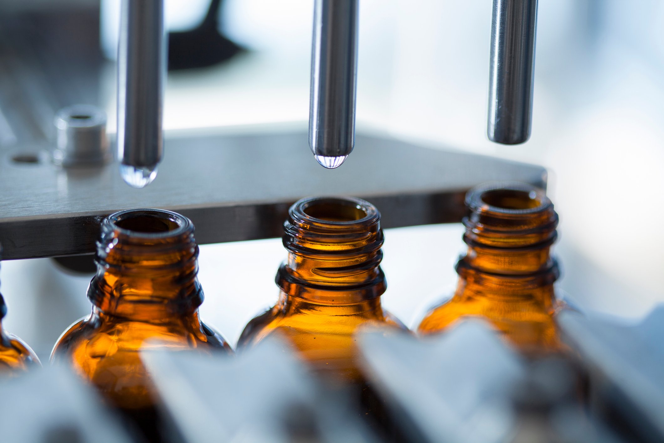 Bottles are filled with product on a pharmaceutical production line.