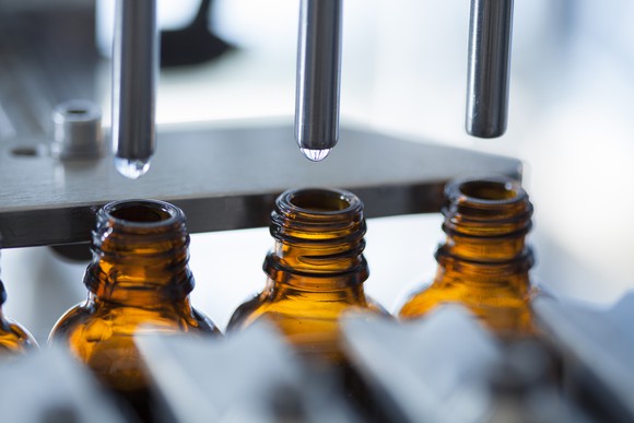 Bottles are filled with product on a pharmaceutical production line.