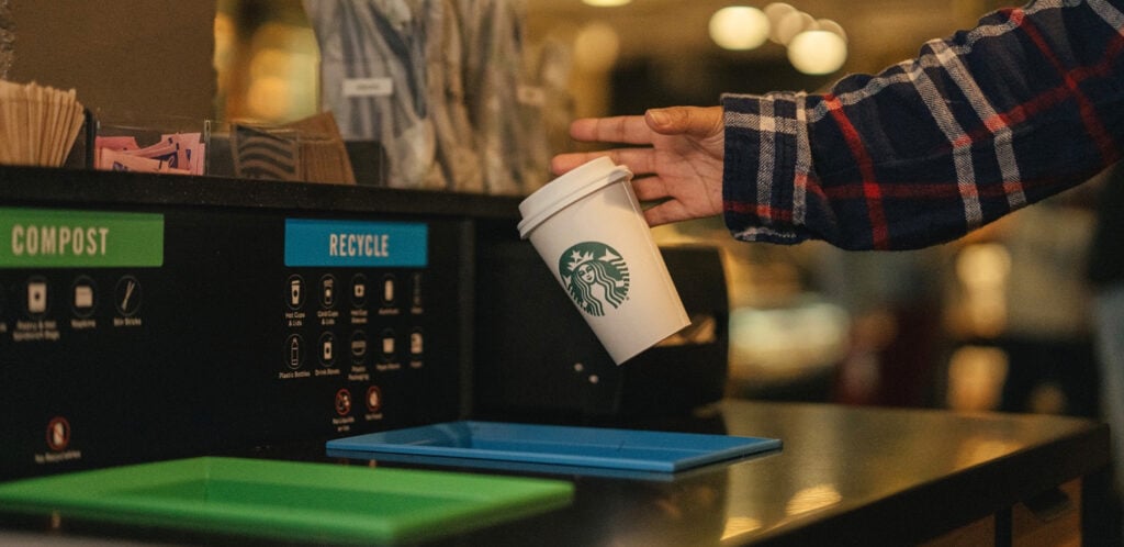 A Starbucks cup is being recycled 