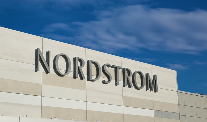 A close-up of the Nordstrom logo on the outside of a store.