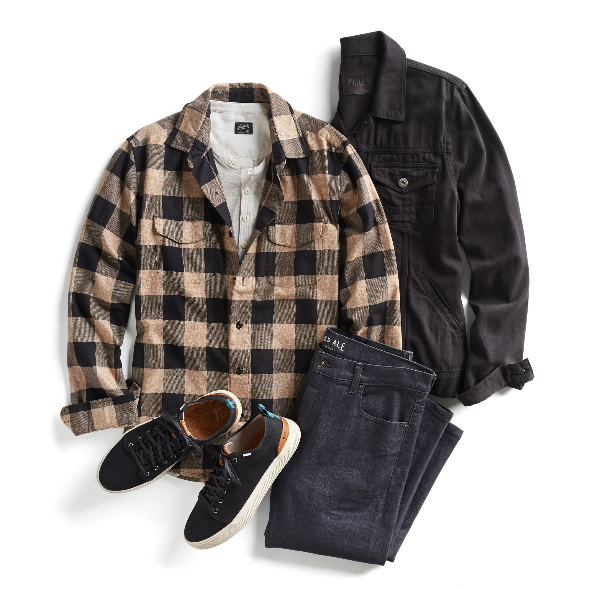 Various men's pieces -- black jeans, black jeans jacket, tan-and-brown checked flannel shirt over a white shirt, and a pair of black sneakers.