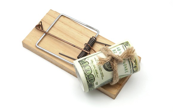Wood mousetrap with roll of $100 bills as bait.