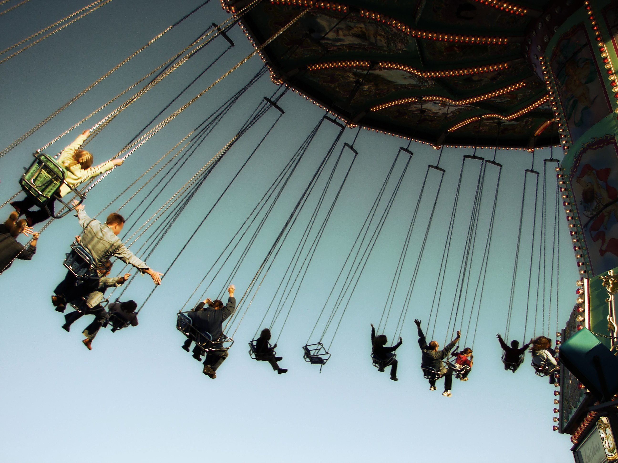 Visitors at a theme park on a swinging ride.
