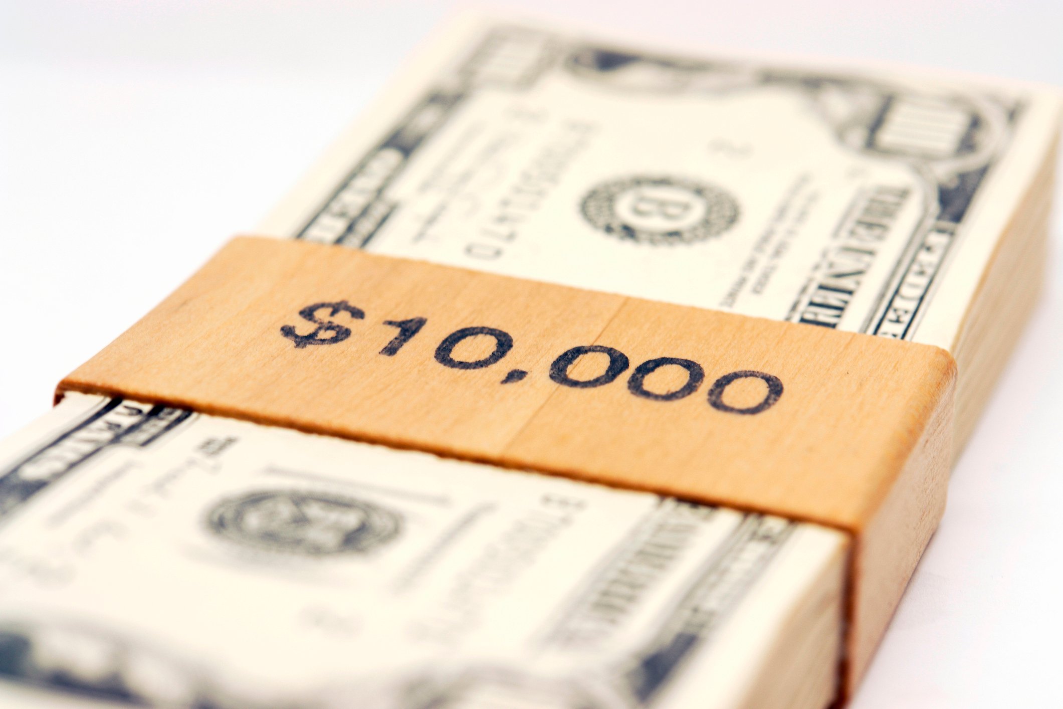 Stack of $100 bills with "$10,000" printed on the money clip