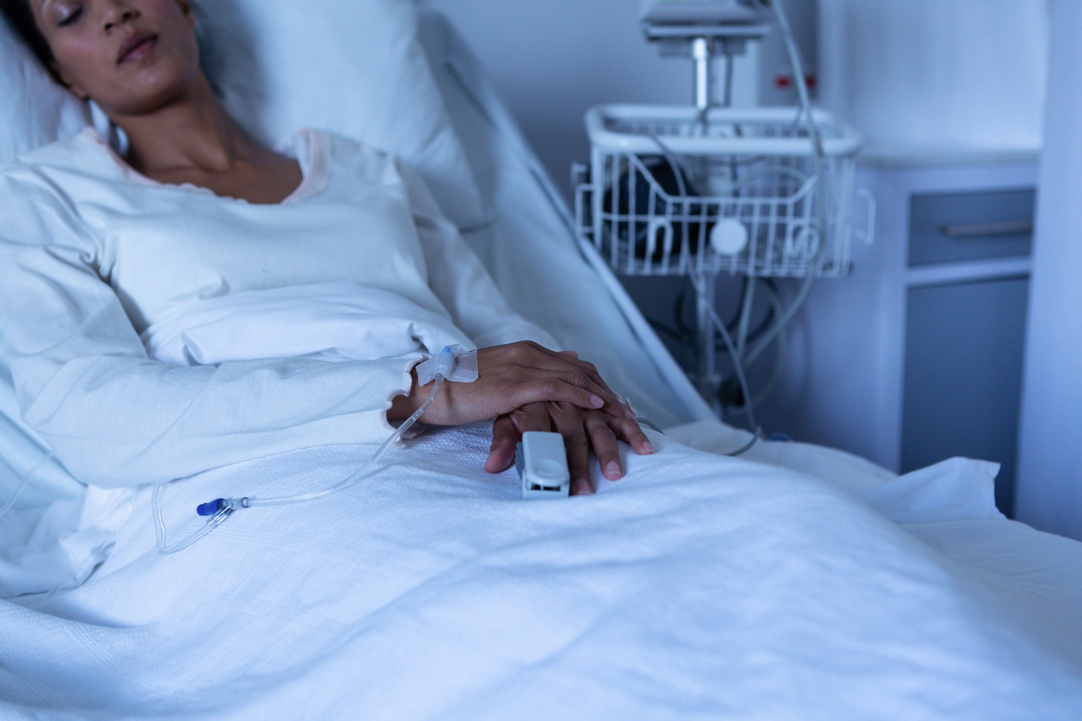 Woman lying in a hospital bed, asleep