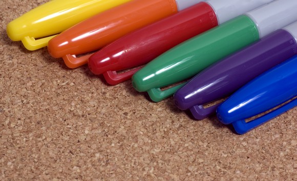 Six Sharpie markers of various colors arranged together