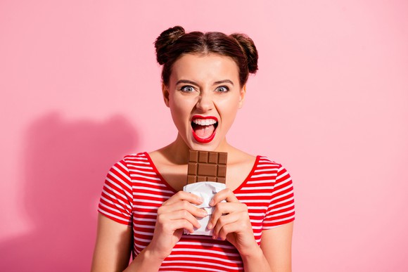 Girl about to eat a chocolate bar