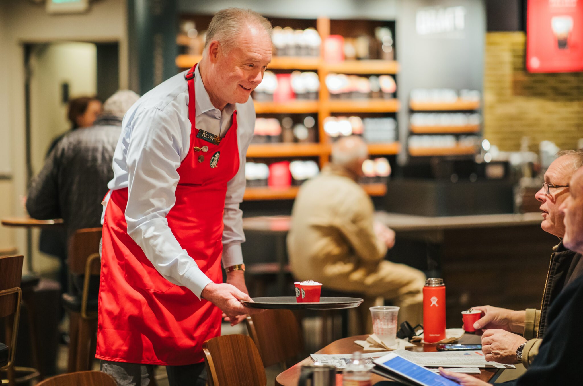 Starbucks CEO Kevin Johnson works in a store.