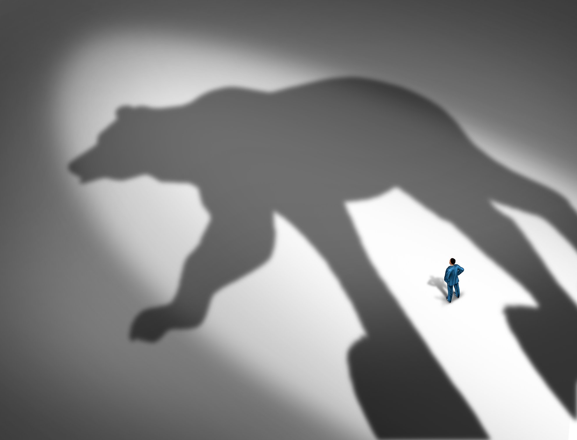 Giant shadow of a bear with a tiny man staring at the shadow