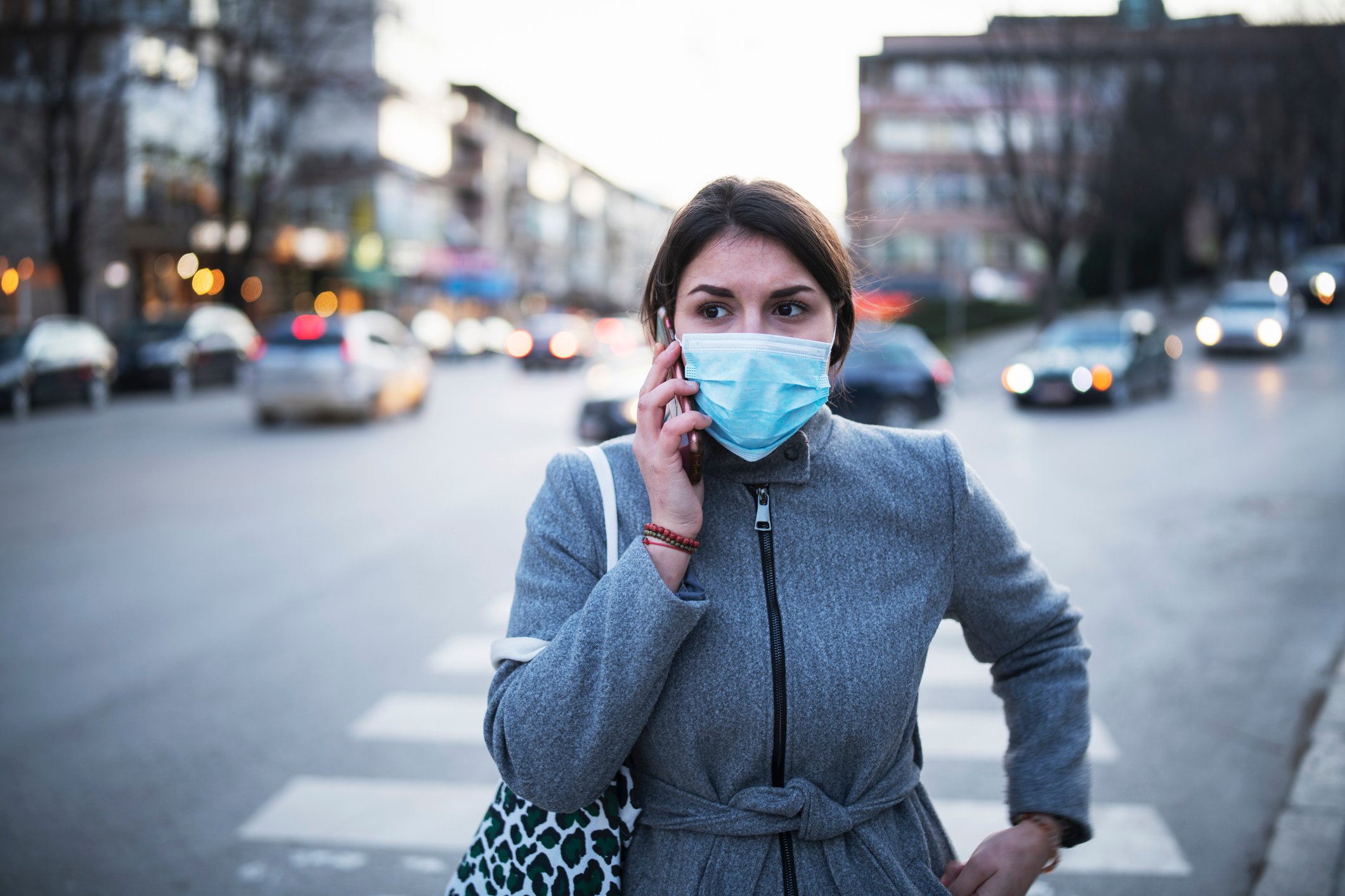 Woman wearing face mask talking on the phone