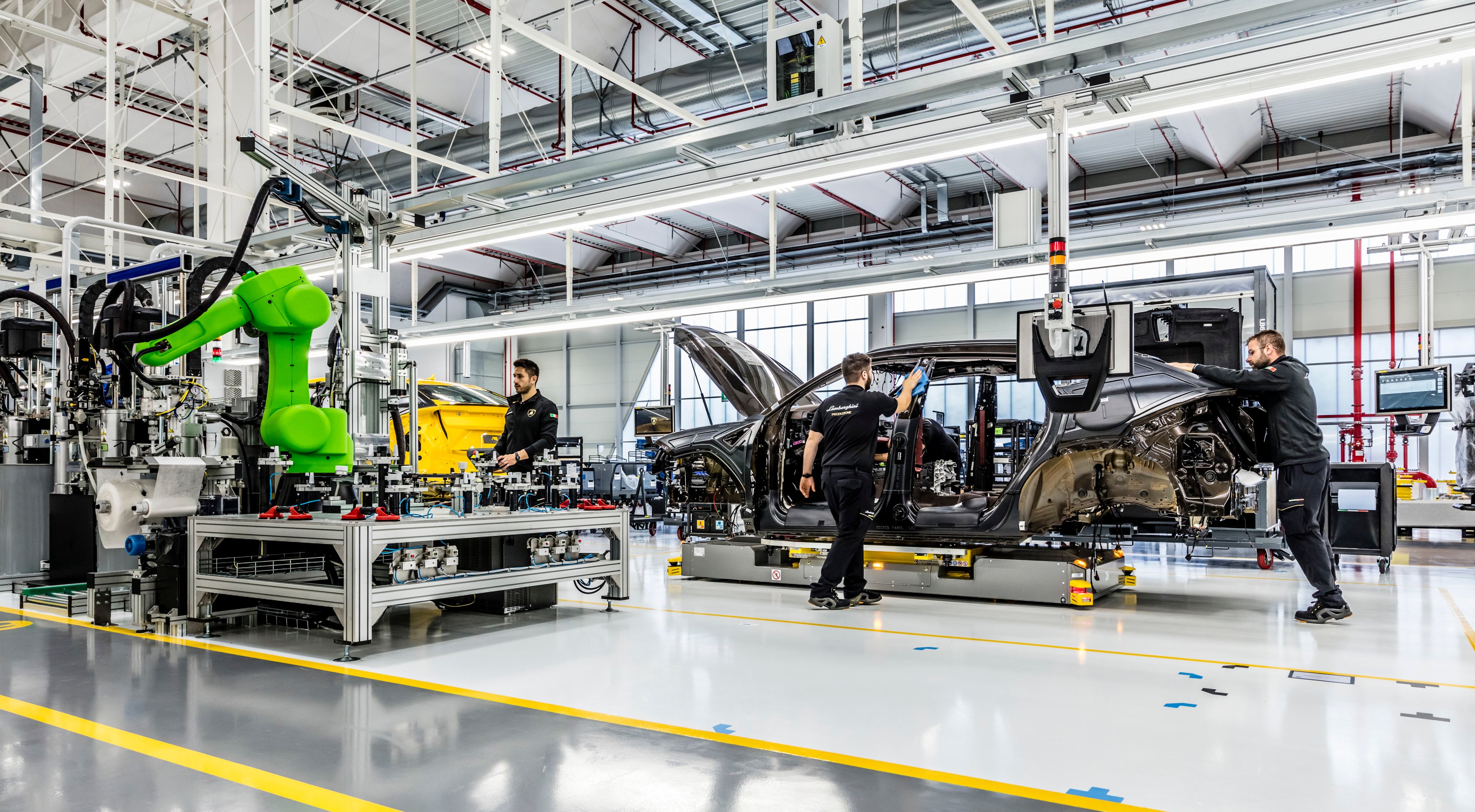 The floor of Lamborghini's factory, with several partially-assembled vehicles visible.