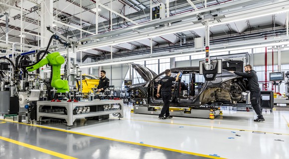 The floor of Lamborghini's factory, with several partially-assembled vehicles visible.