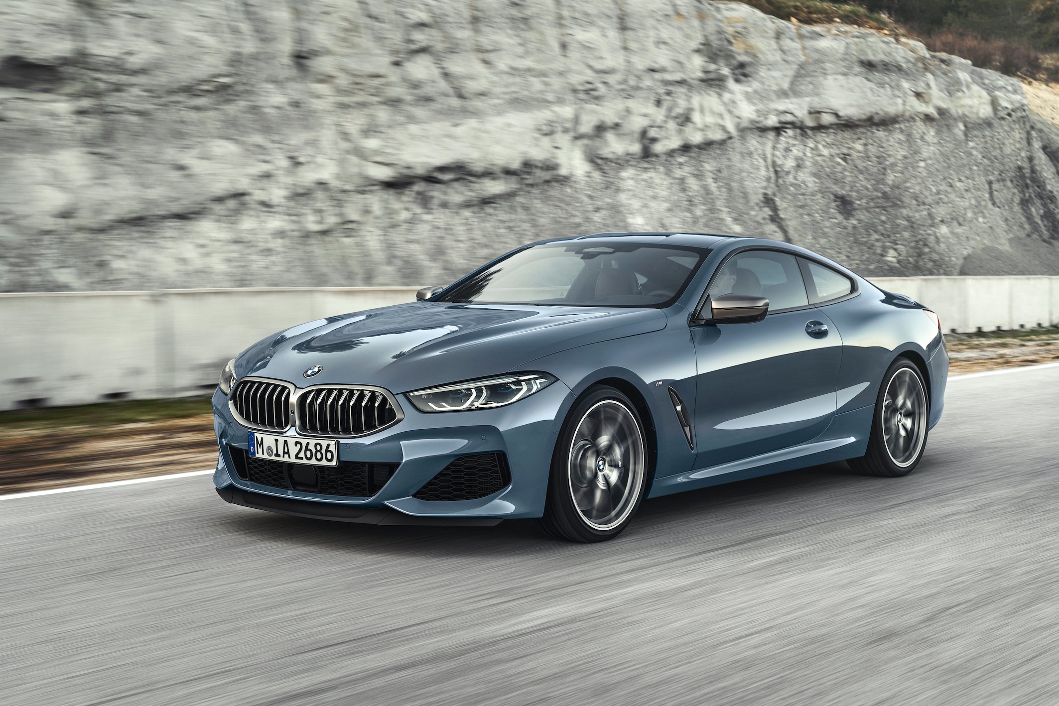 A blue BMW 8 Series, a luxury coupe.