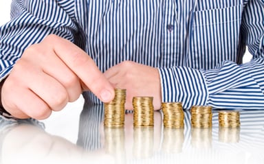 Man stacking coins in piles that grow