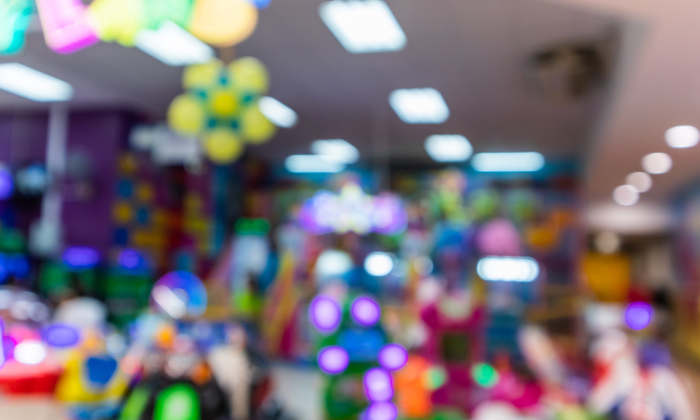 Blurry shot of a kids arcade and play center.