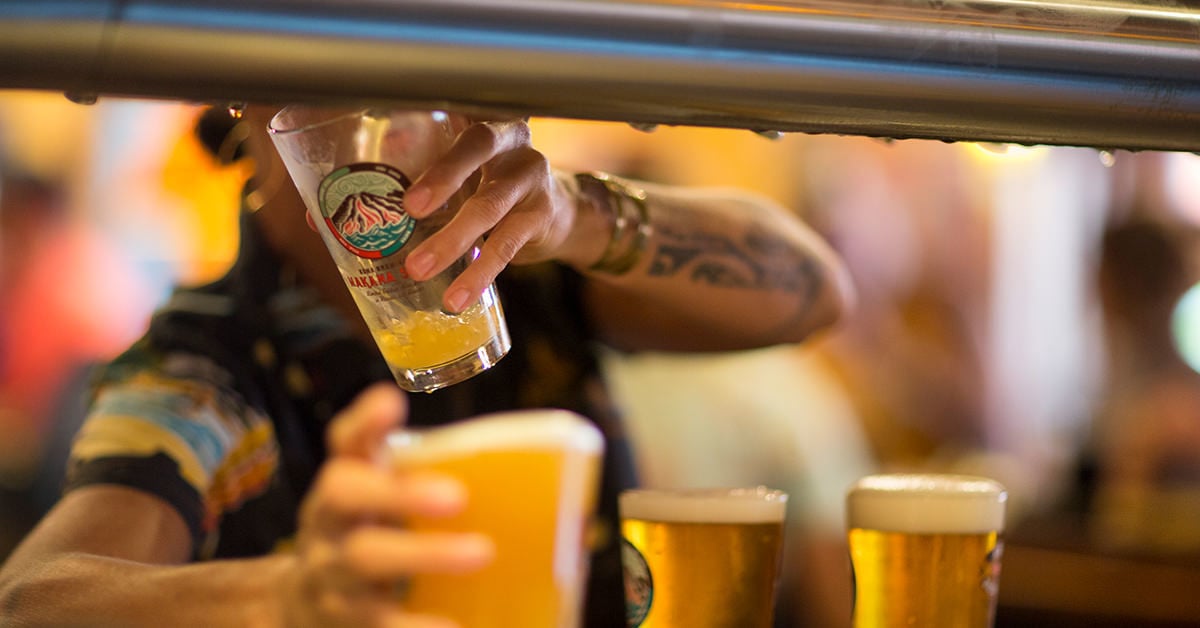 Bartender pouring Kona Brewing beer