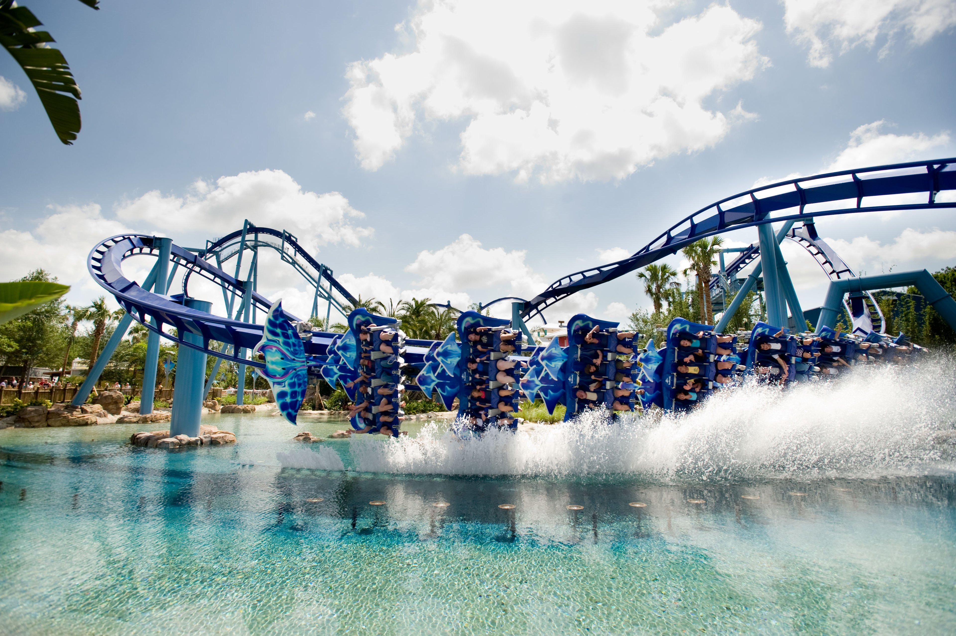 A roller coaster at SeaWorld dips into the water.