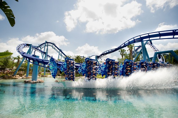 A roller coaster at SeaWorld dips into the water.