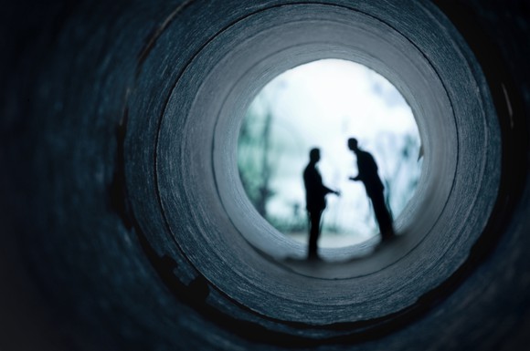 Two businessmen meeting in secret. 