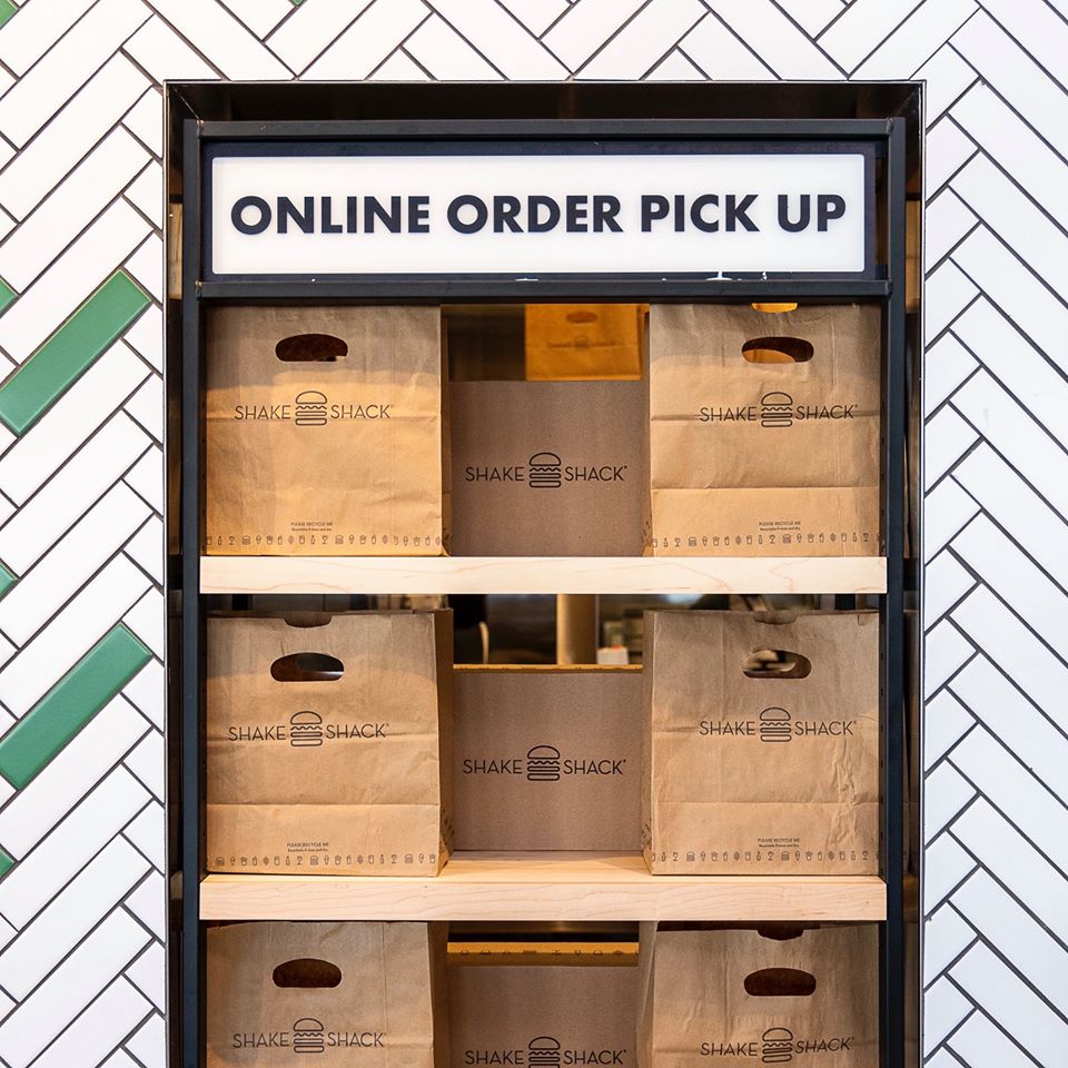 Shake Shack bags ready for online order pick-up.