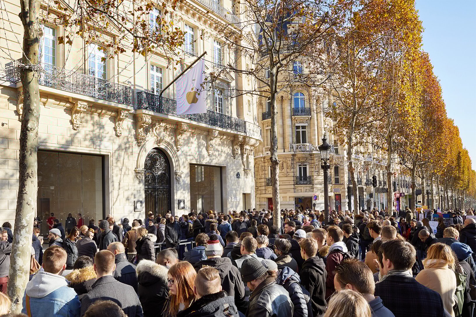 Champs Elysees Apple Store exterior shot with crowds of people outside