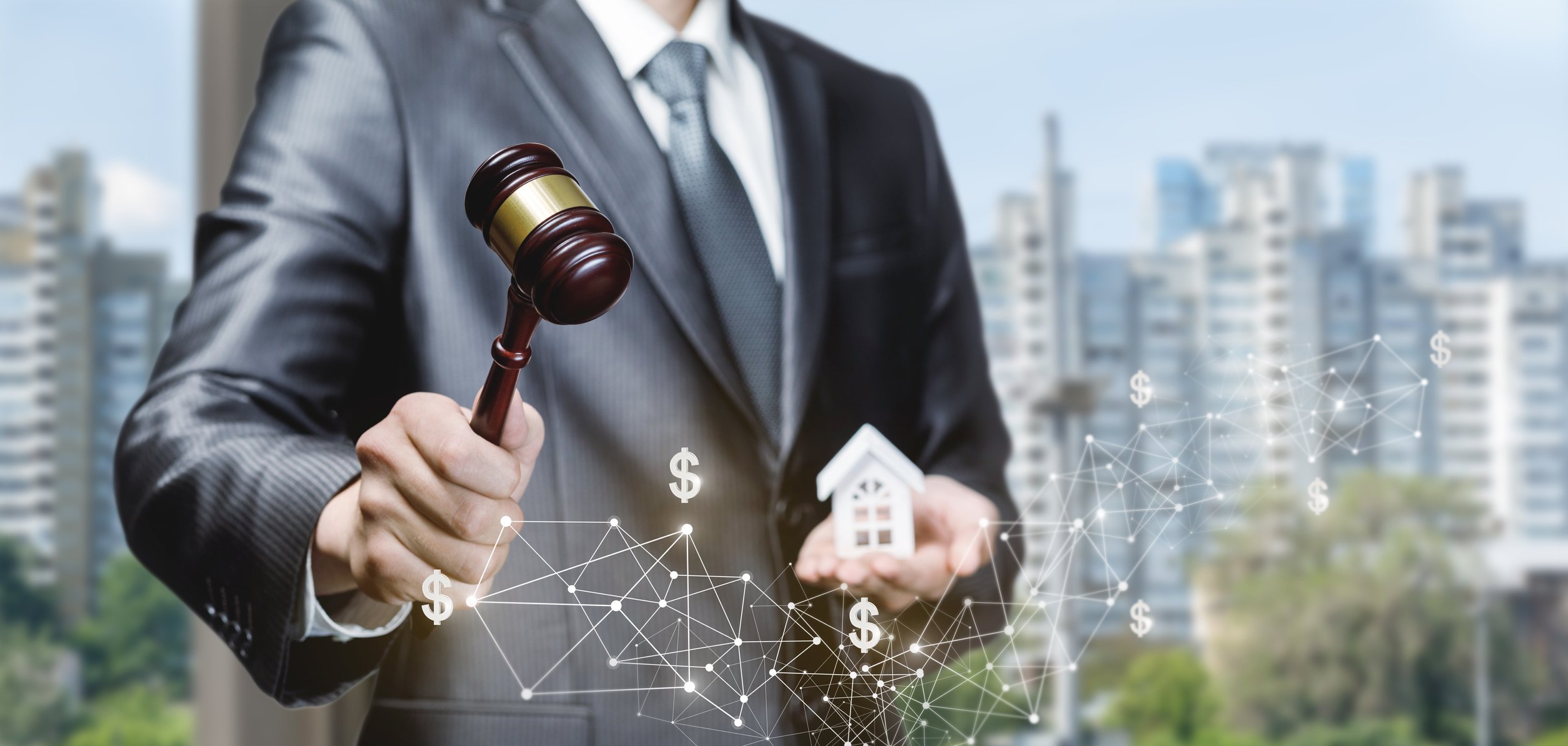 A man holds a gavel and a digitized house.
