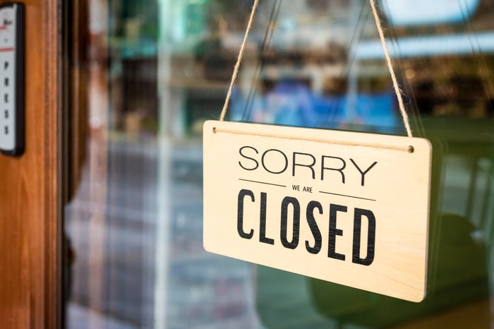 'Sorry, we are closed' sign hung on restaurant door