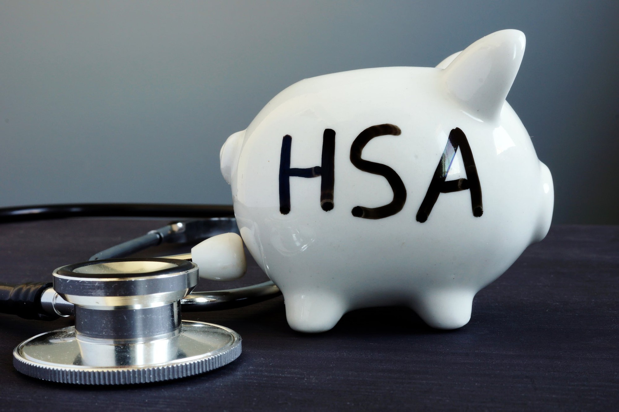 White piggy bank with HSA written on it in black