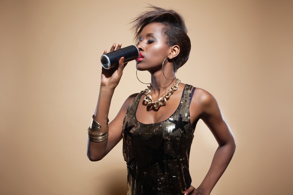 Woman drinking from a can.