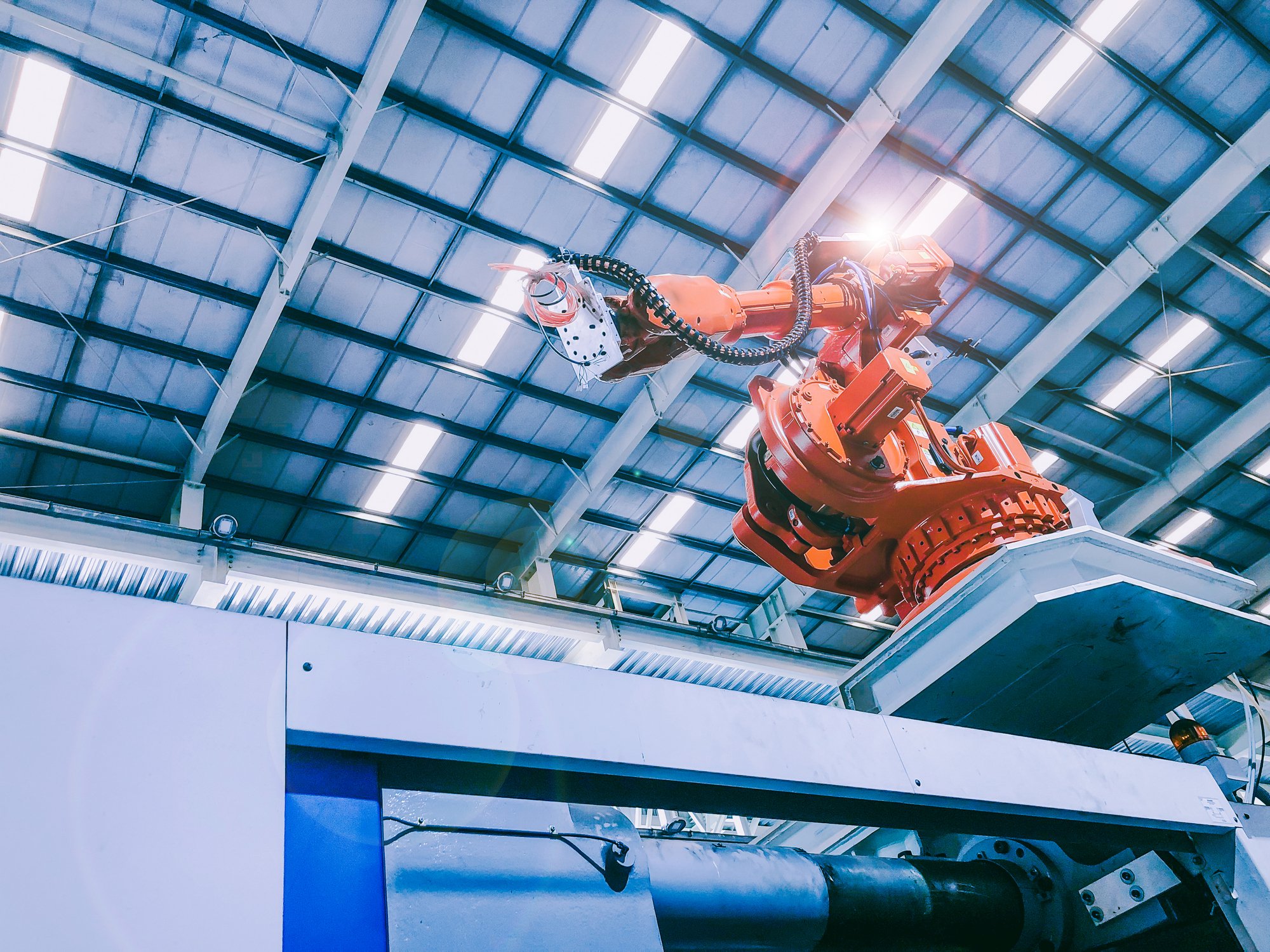 Robotic arm working in an auto production facility.