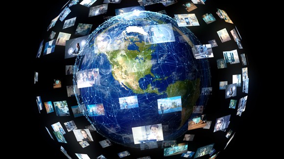 Earth surrounded by video screens of people