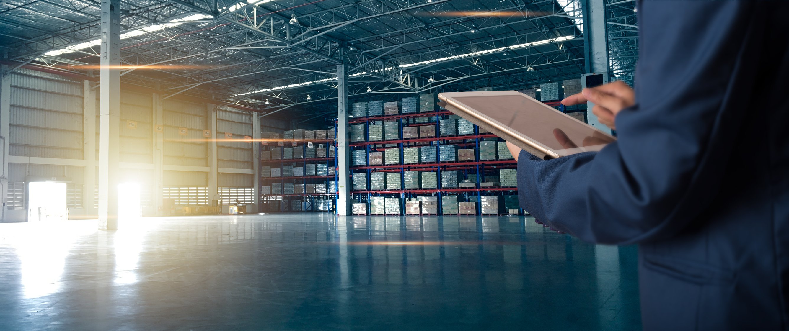 Images shows a delivery warehouse and a man taking stock of inventory
