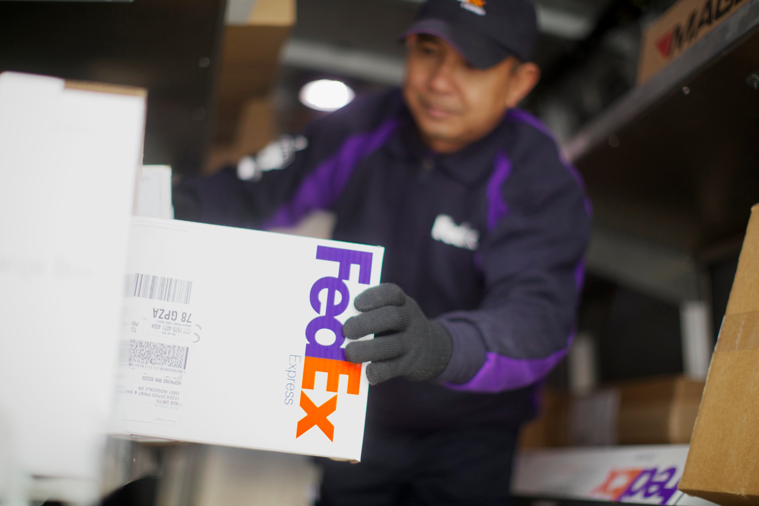 FedEx employee handling a package.