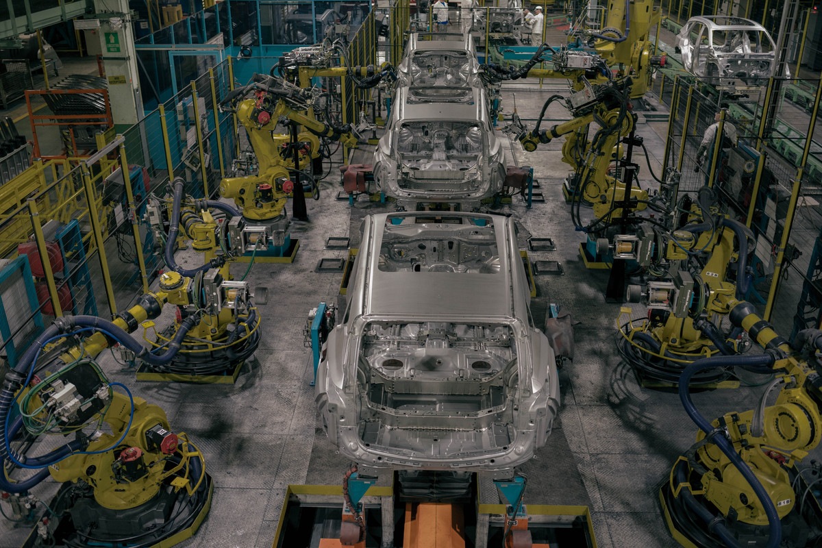 Partially-assembled Acura RDX SUVs move down an assembly line amid robots at Honda's plant in East Liberty, Ohio.
