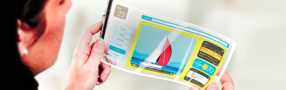 A woman holds a flexible OLED display, showing a colorful image while she bends the screen.