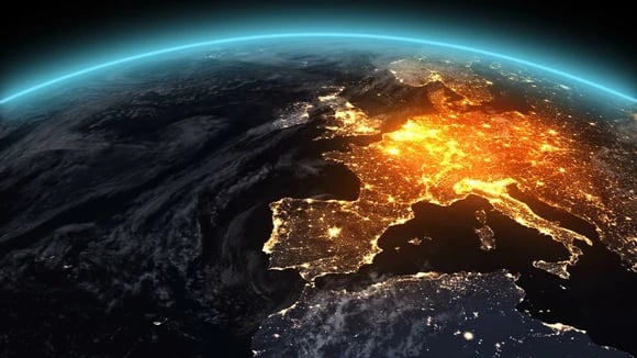 Europe at night from orbit, with lights prominently highlighting populated areas.