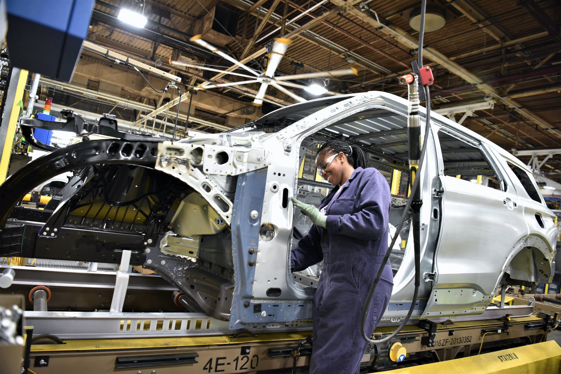 A worker attaches parts to a partially-assembled Ford Explorer at Ford's Chicago Assembly Plant.