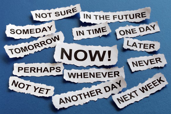 Slips of paper with words printed for different levels of urgency, including "now," "someday," "later," "another day," and "next week"