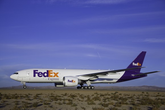 A FedEx cargo 777 sits on the runway.